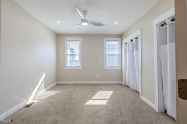 unfurnished bedroom featuring recessed lighting, light colored carpet, and baseboards