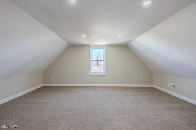 bonus room featuring baseboards, visible vents, carpet floors, recessed lighting, and vaulted ceiling