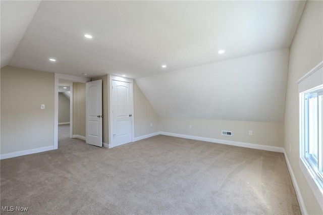 bonus room featuring visible vents, recessed lighting, lofted ceiling, and baseboards