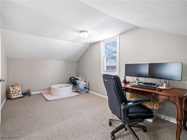 carpeted office space featuring vaulted ceiling, baseboards, and a textured ceiling