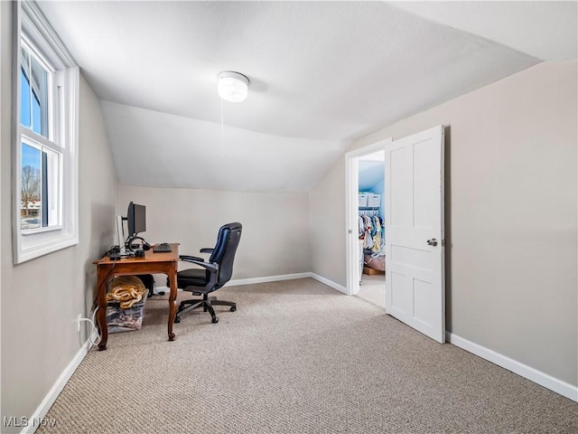 office area with lofted ceiling, baseboards, and carpet floors