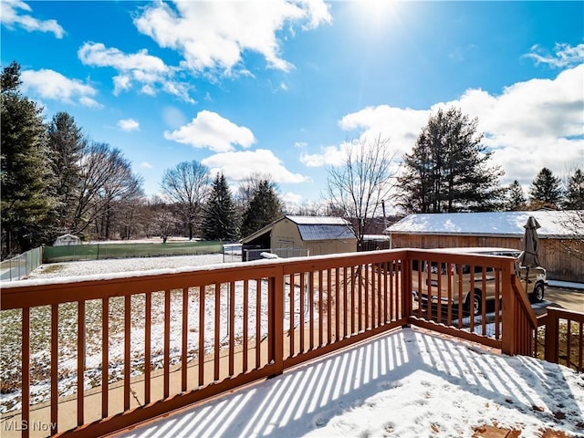 snow covered deck with fence