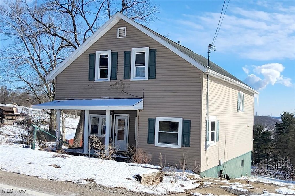 traditional-style home featuring covered porch