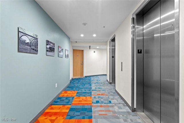 corridor featuring elevator, recessed lighting, and baseboards