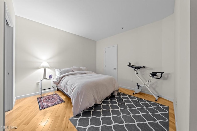 bedroom featuring baseboards and wood finished floors