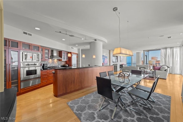 dining space featuring visible vents, recessed lighting, and light wood-type flooring