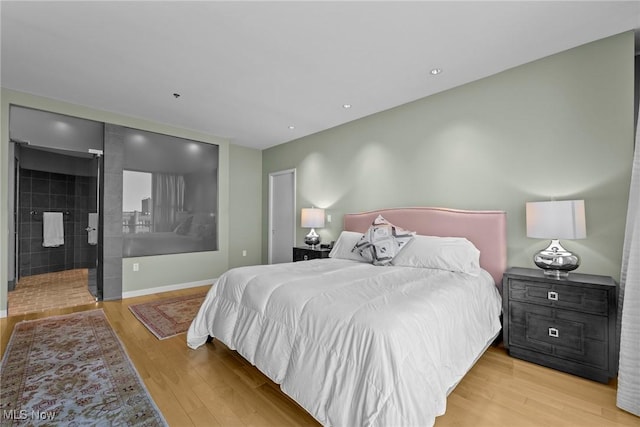 bedroom with baseboards and wood finished floors