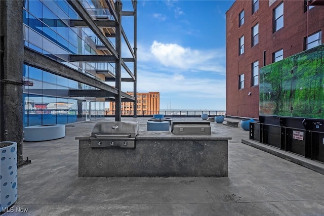 view of patio with grilling area and an outdoor kitchen