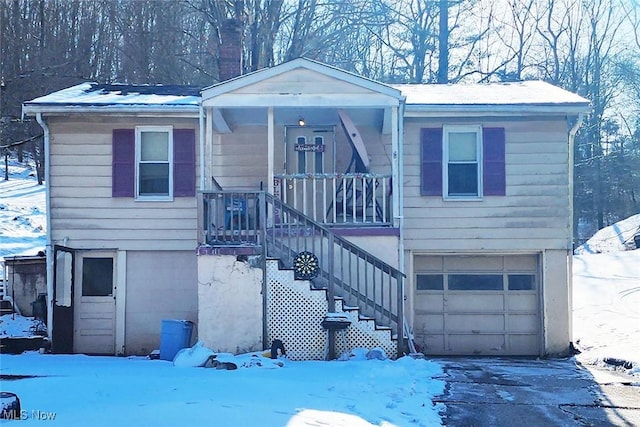 view of front of house with stairway, driveway, and a garage