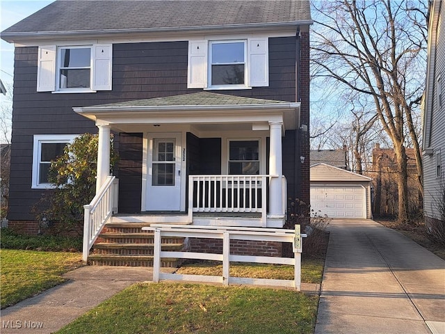 view of front of home featuring a garage, an outbuilding, a porch, and roof with shingles