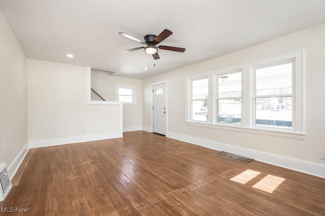 unfurnished living room featuring visible vents, a ceiling fan, hardwood / wood-style flooring, recessed lighting, and baseboards