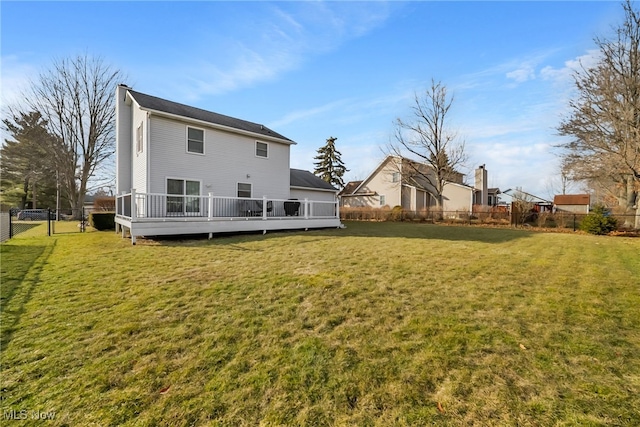 back of property featuring a fenced backyard, a deck, a yard, and a gate