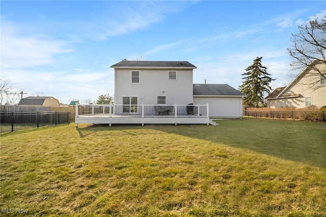 back of property featuring a lawn, a wooden deck, and a fenced backyard