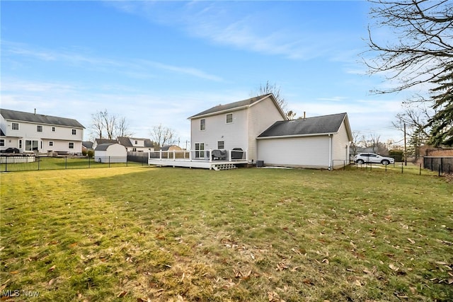 back of house featuring a fenced backyard, a wooden deck, and a yard