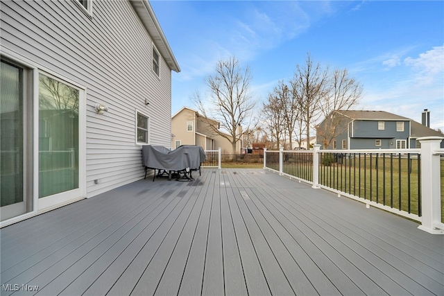 wooden deck with a residential view and a lawn