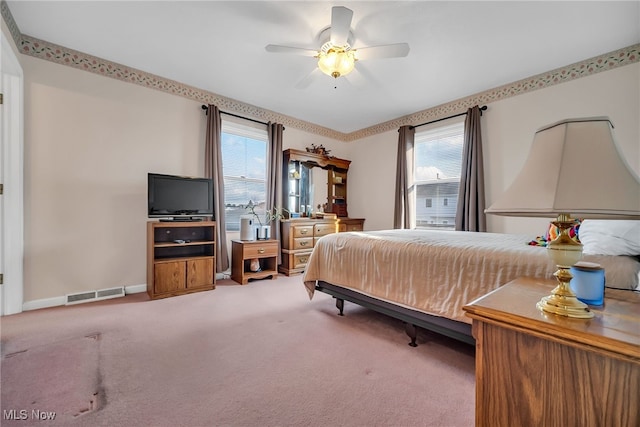 bedroom featuring baseboards, visible vents, multiple windows, and carpet floors