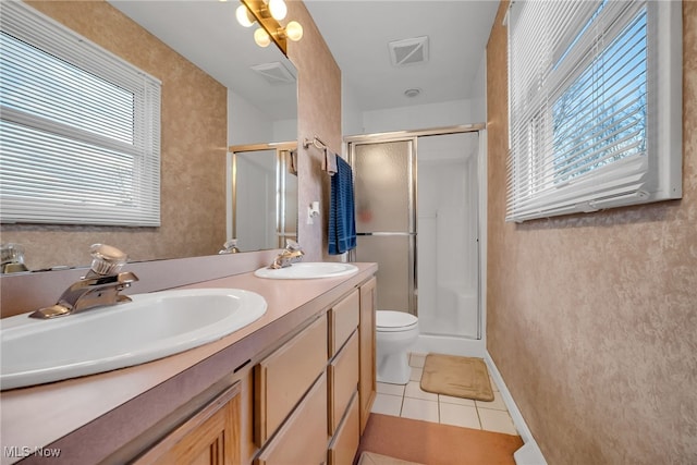 full bathroom with tile patterned floors, a stall shower, visible vents, and a sink