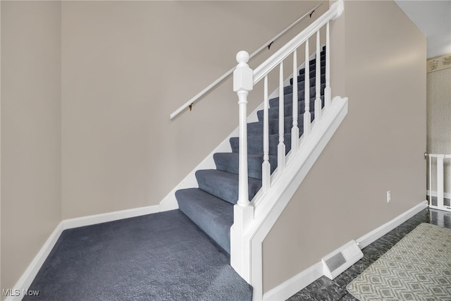 stairs with baseboards and visible vents