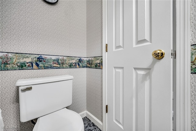 bathroom with toilet and wallpapered walls