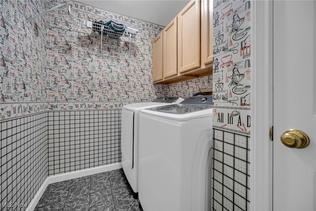 laundry room with washer and clothes dryer and cabinet space