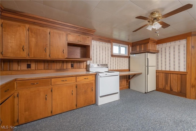 kitchen with white appliances, ceiling fan, brown cabinetry, and light countertops