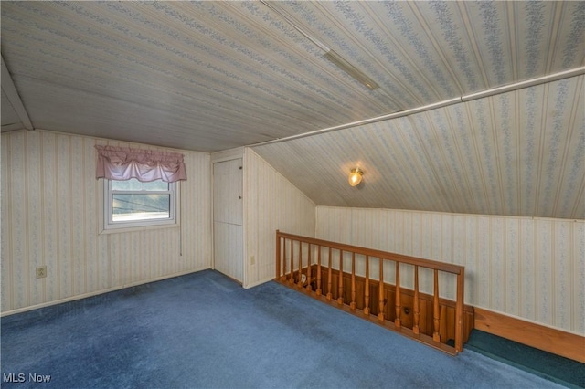 bonus room featuring wallpapered walls, vaulted ceiling, and carpet flooring