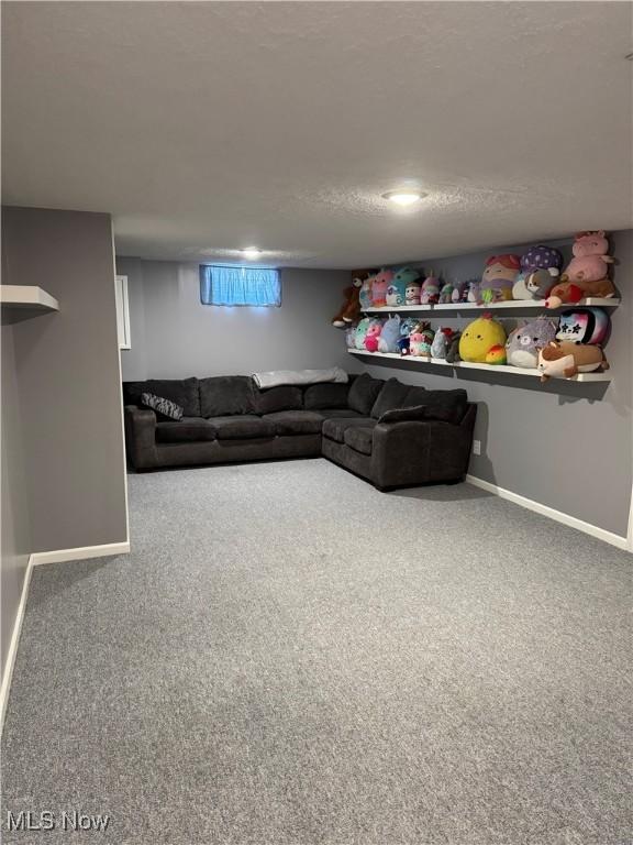 carpeted living room with baseboards and a textured ceiling