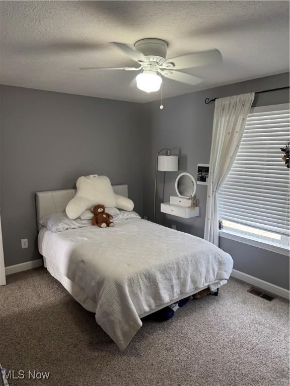 bedroom with visible vents, baseboards, and carpet floors