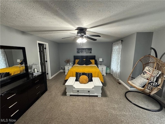 carpeted bedroom with a textured ceiling, baseboards, and a ceiling fan