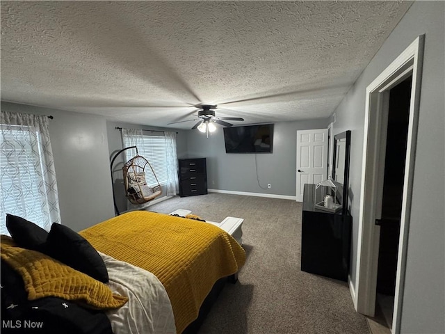 carpeted bedroom featuring ceiling fan, a textured ceiling, and baseboards