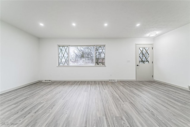 empty room with recessed lighting, visible vents, baseboards, and light wood-style flooring