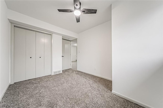 unfurnished bedroom featuring visible vents, a ceiling fan, a closet, carpet, and baseboards