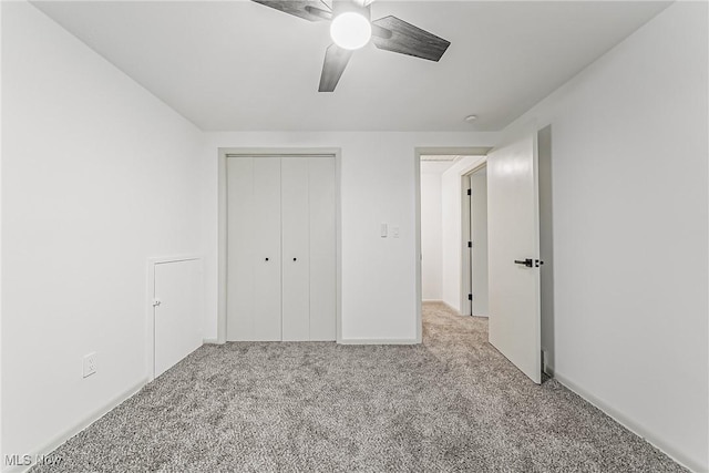 unfurnished bedroom with a closet, ceiling fan, and carpet floors