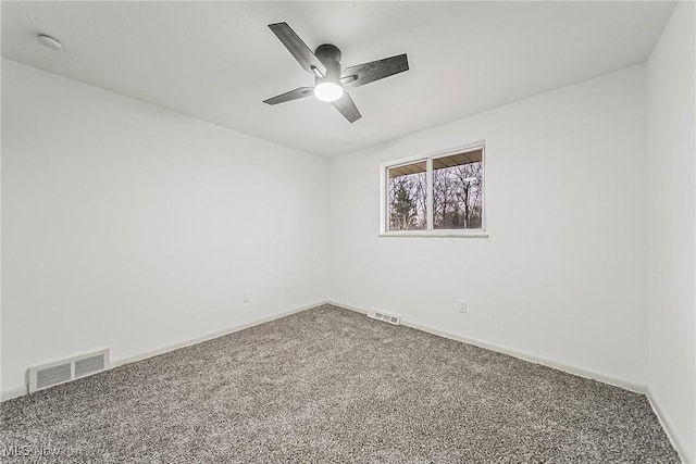 unfurnished room with baseboards, carpet, visible vents, and ceiling fan