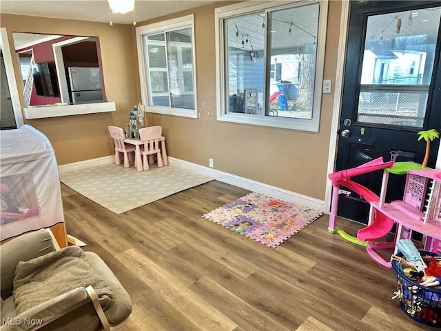 interior space with baseboards and wood finished floors