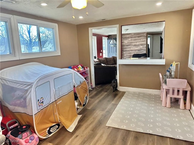 bedroom with recessed lighting, visible vents, baseboards, and wood finished floors