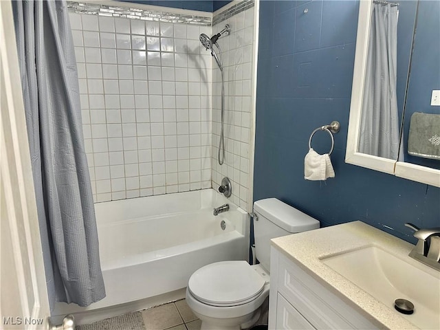 full bath featuring tile patterned flooring, toilet, vanity, and shower / bath combo