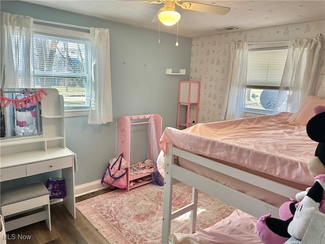 bedroom featuring visible vents, dark wood-type flooring, and baseboards