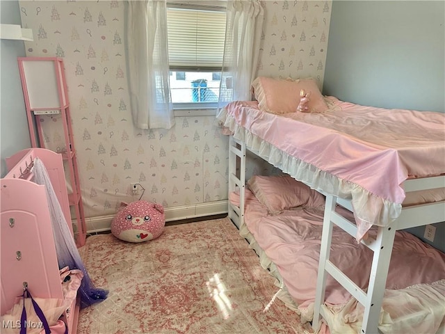 bedroom with wallpapered walls and baseboards