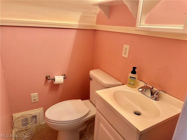 half bathroom featuring vanity, toilet, and tile patterned flooring