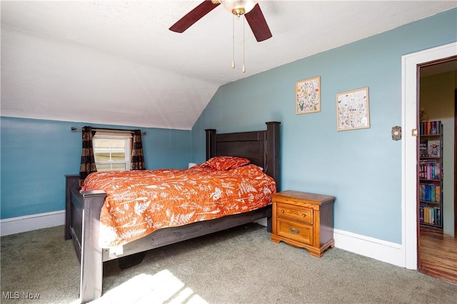 bedroom featuring baseboards, lofted ceiling, and carpet flooring