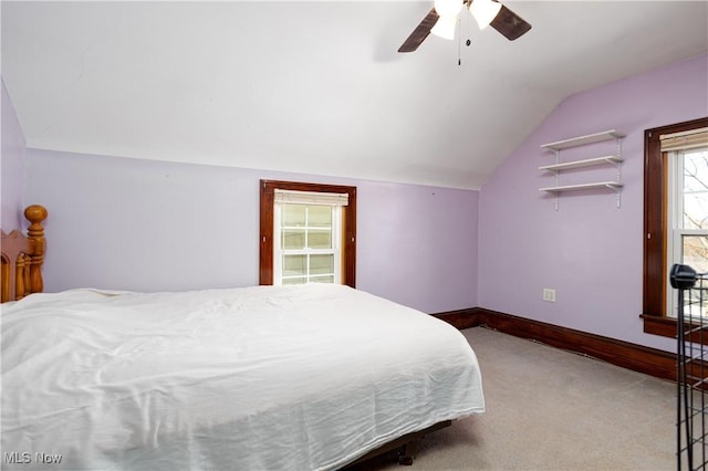 bedroom with carpet flooring, ceiling fan, baseboards, and lofted ceiling