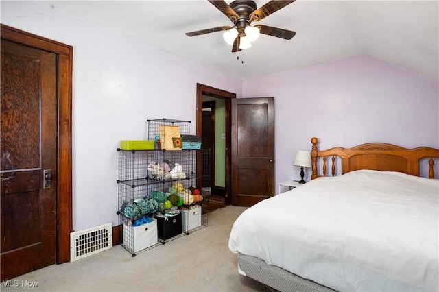 bedroom featuring visible vents, a ceiling fan, lofted ceiling, and carpet