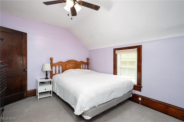 bedroom with baseboards, ceiling fan, carpet flooring, and vaulted ceiling