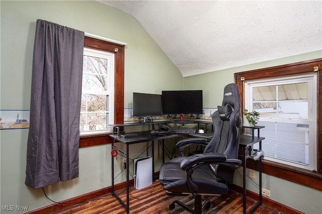 home office with lofted ceiling, wood finished floors, baseboards, and a textured ceiling