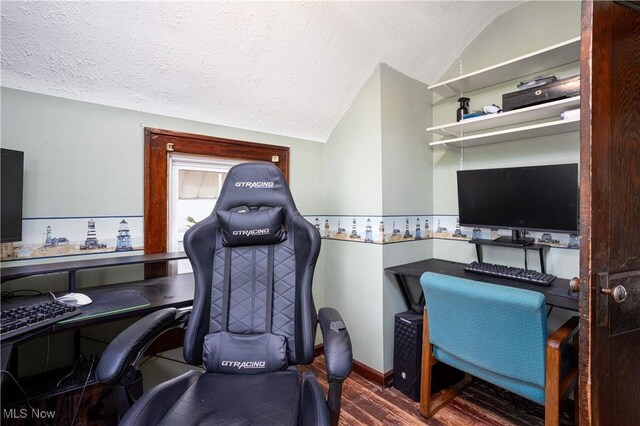 home office featuring a textured ceiling, lofted ceiling, and wood finished floors