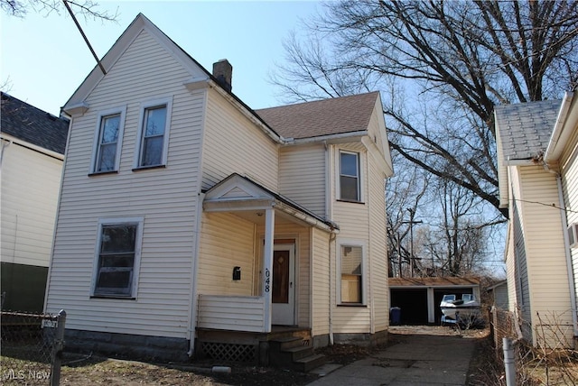 view of front facade featuring a shingled roof, a chimney, and entry steps