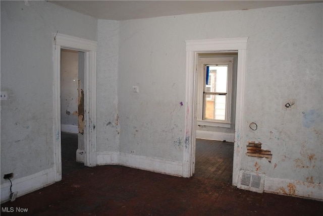 unfurnished room with visible vents and hardwood / wood-style floors