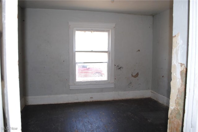 unfurnished room with hardwood / wood-style flooring