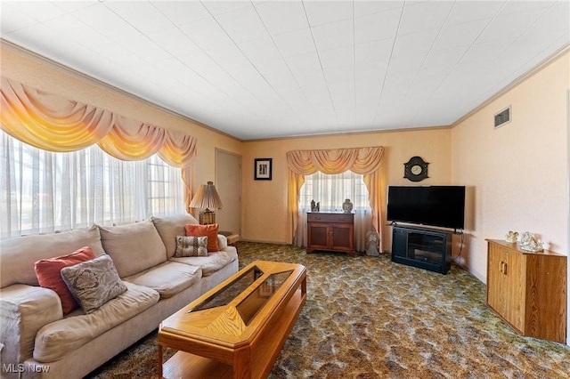 living area with visible vents, carpet floors, and ornamental molding